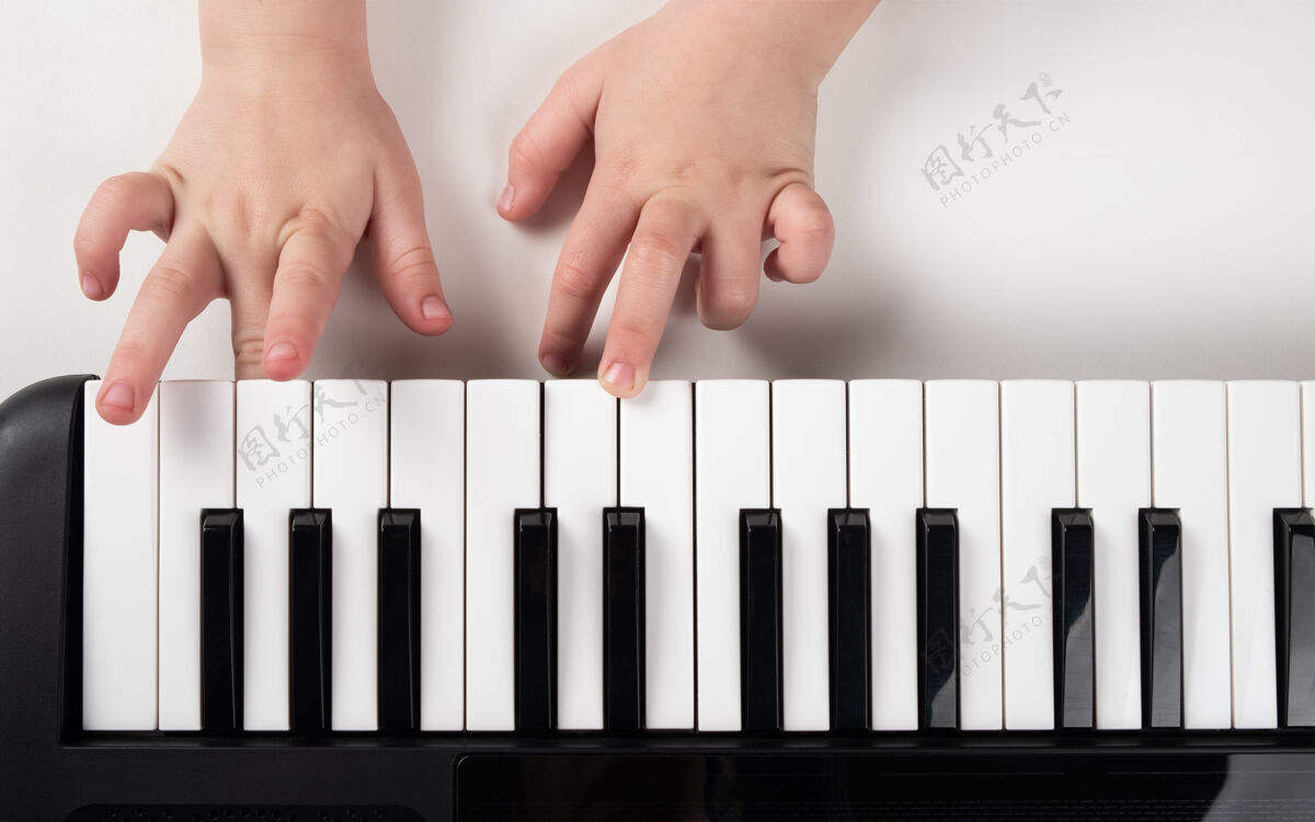 野心学习弹钢琴 小女孩手上合成器键特写愿望小象牙