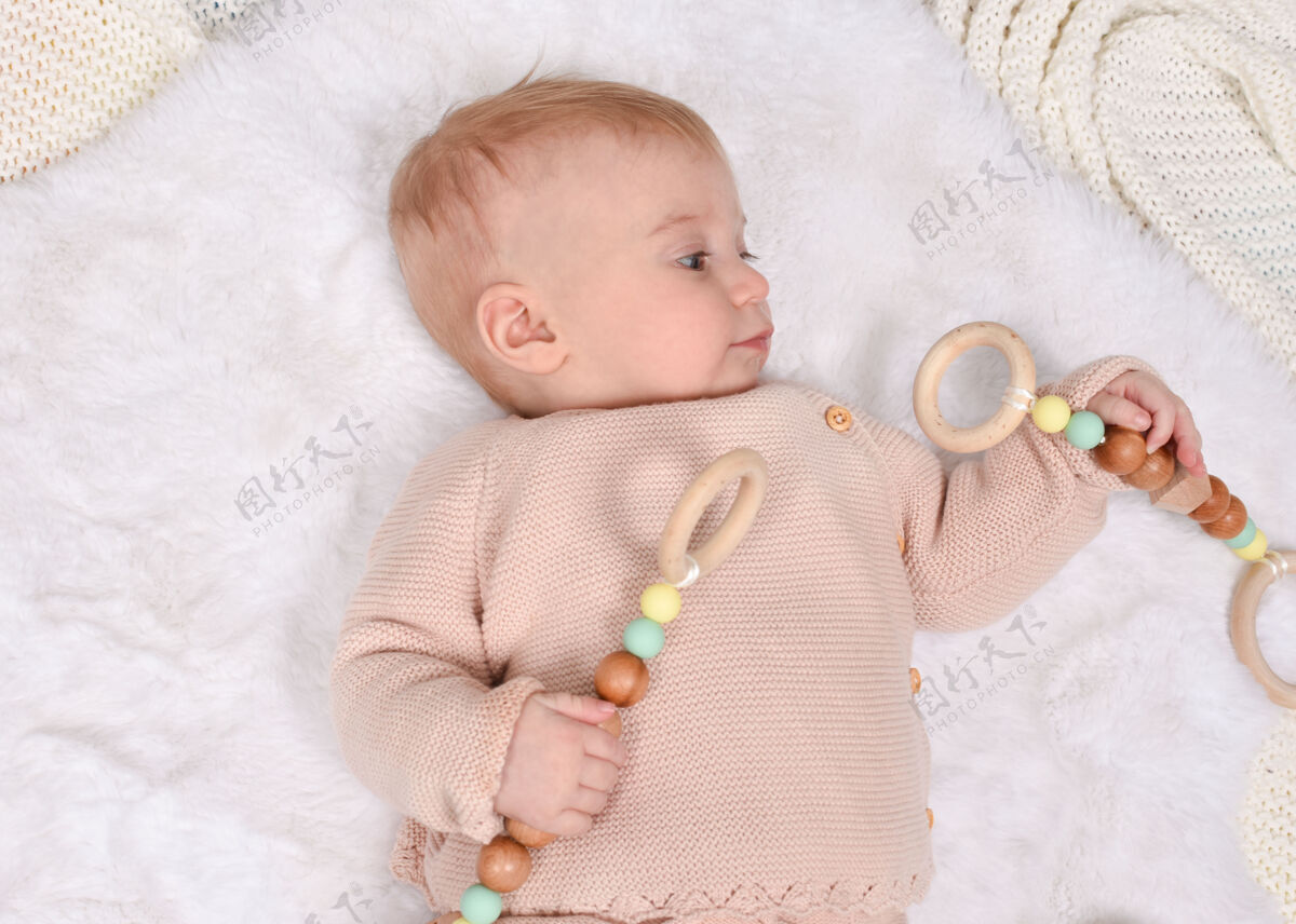 教育可爱的白人小宝宝玩环保木制玩具金发木头婴儿