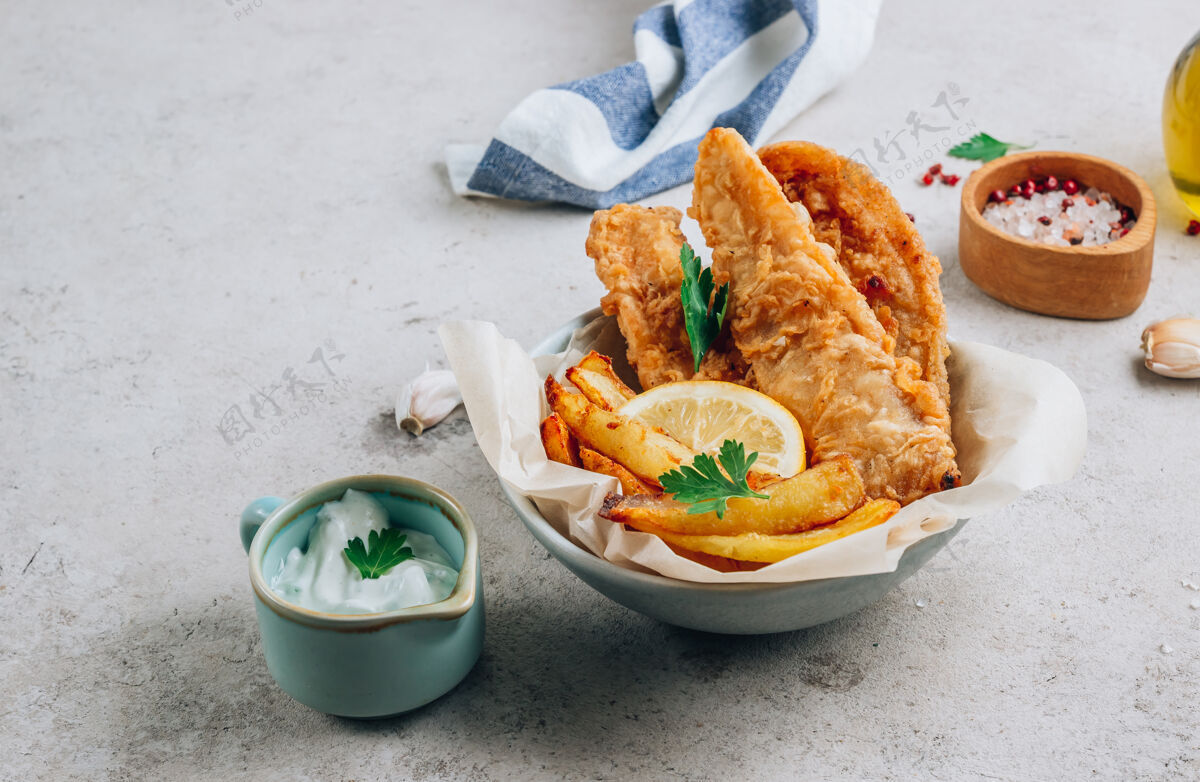 法国传统的英国炸鱼和薯条 在轻质混凝土上加上鞑靼沙司背景选择性集中鱼晚餐午餐