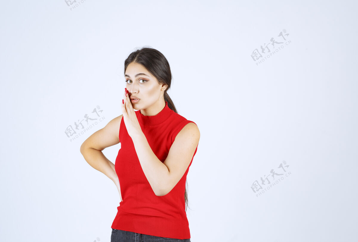 成人穿红衬衫的女孩把手放在嘴里低声说雇员模特信息
