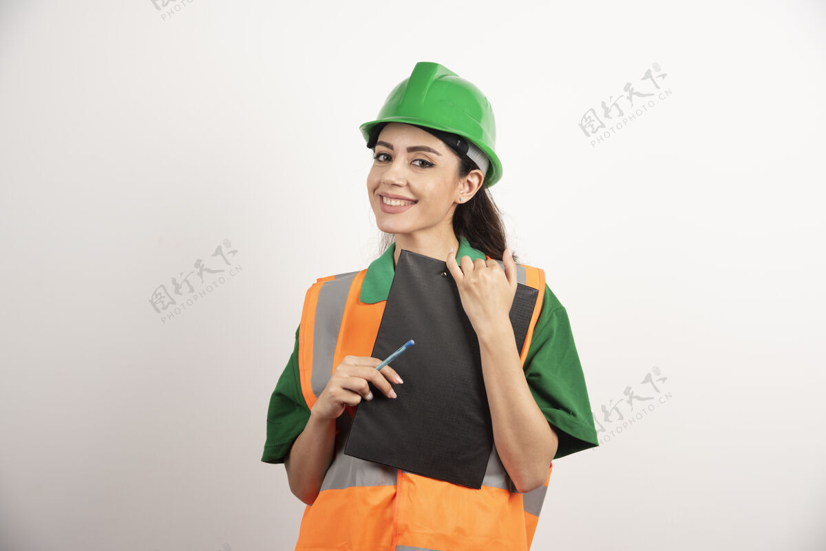 人微笑的女建设者拿着白色背景上的剪贴板高品质的照片女孩工人女人