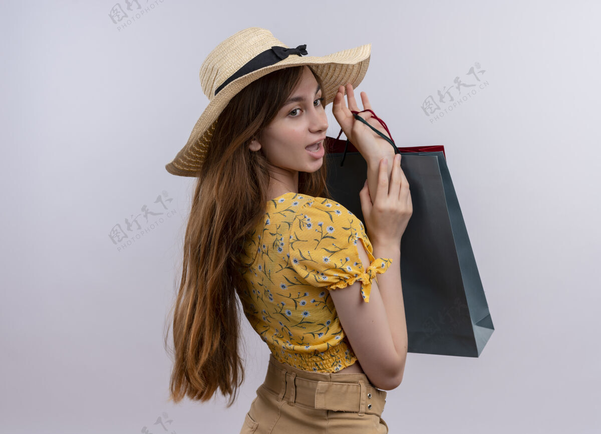 年轻印象深刻的年轻女孩拿着纸袋 手放在另一个纸袋上 看着旁边的空白处和复印处女孩手壁板