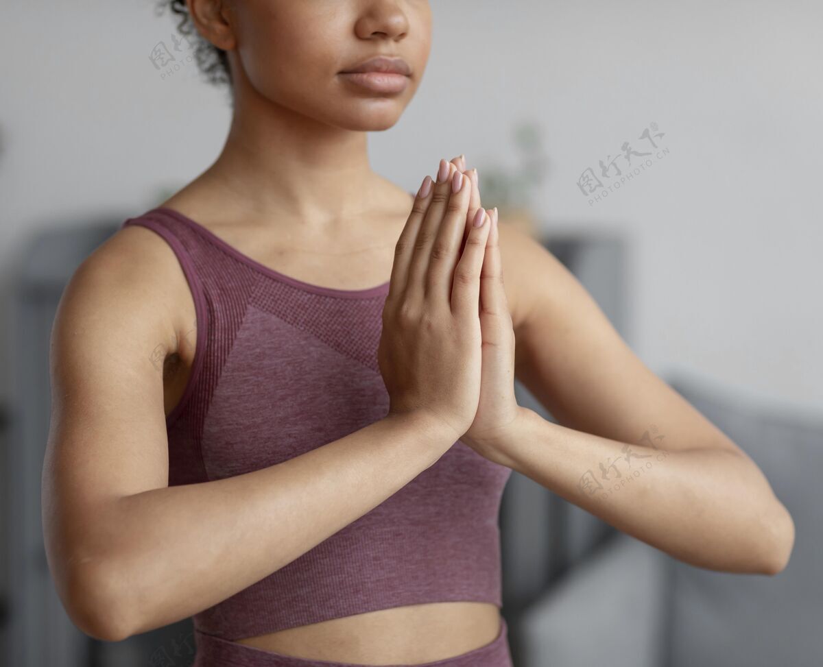 生活方式健身女士在家里用瑜伽垫做瑜伽内心的和平瑜伽姿势姿势