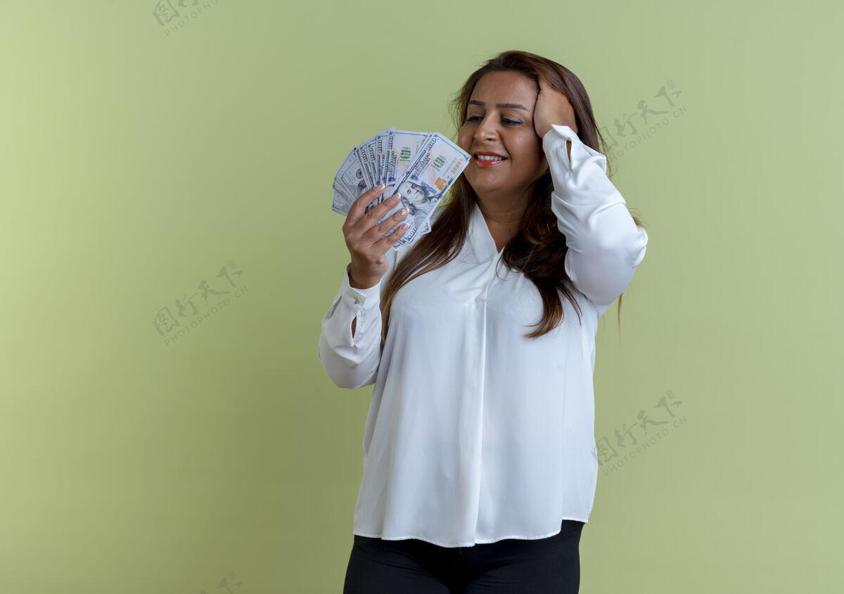 绿色高兴的是随便一个白人中年妇女抱着钱 看着钱 一把抓住了头女人持有中年