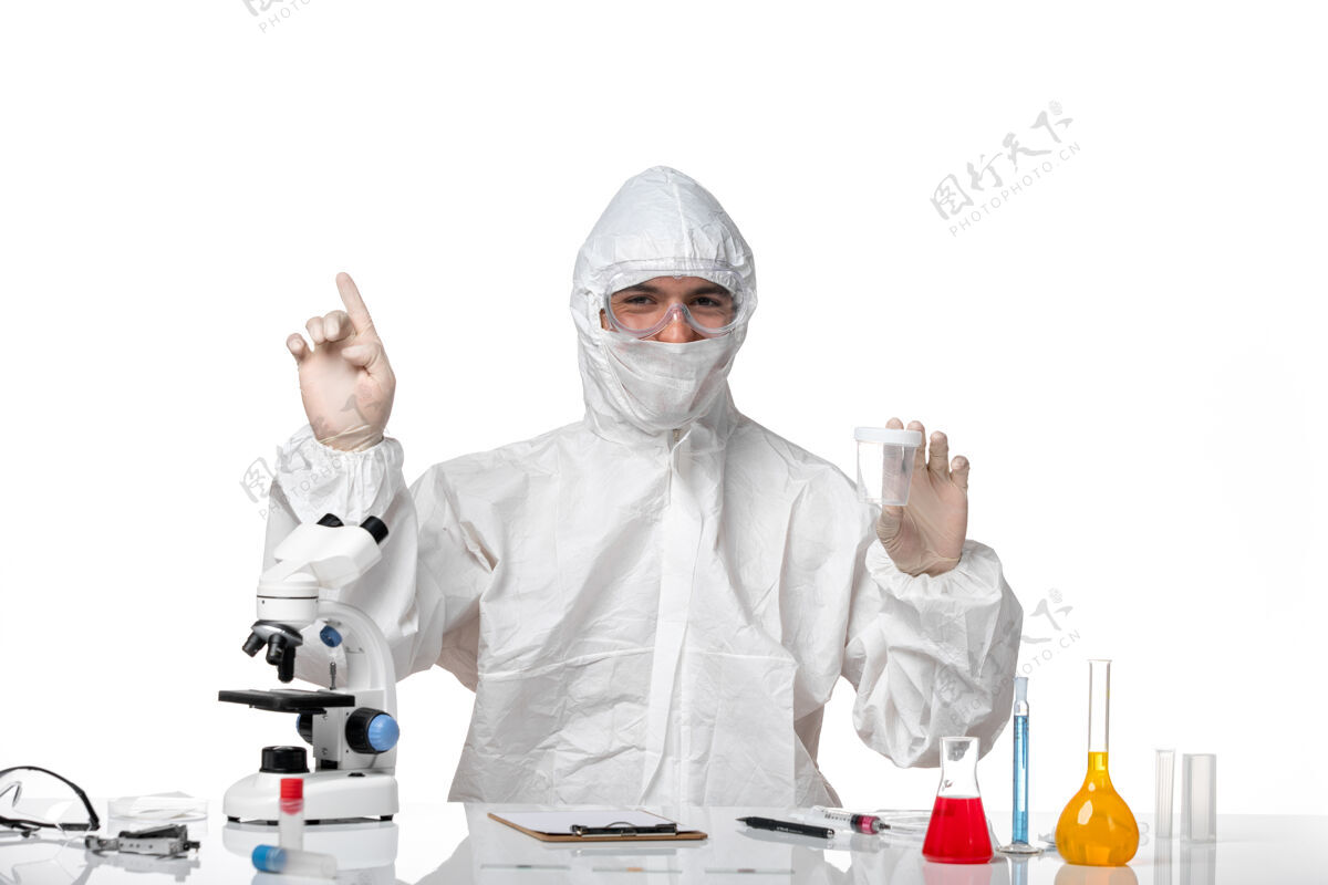套装正面图穿着防护服的男医生拿着空瓶子站在空白处医疗诊所专业