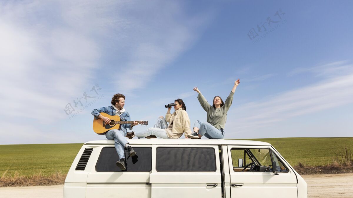 旅行全镜头的人在车上拿着吉他女人冒险放松