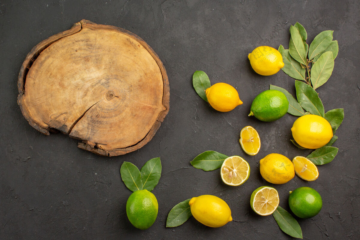 食品顶视图新鲜柠檬酸水果在黑暗的桌子上 酸橙柑橘水果健康蔬菜酸味