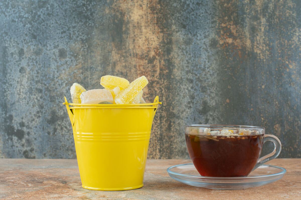 茶一个黄色的桶里装满了糖浆糖和一杯花草茶水桶果酱草药