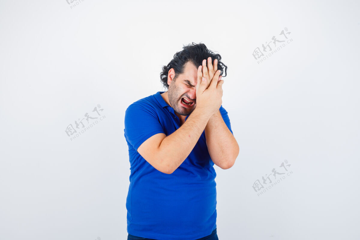 成人穿着蓝色t恤的成熟男人患有偏头痛 看起来很烦躁 正面视图养老金室内年龄