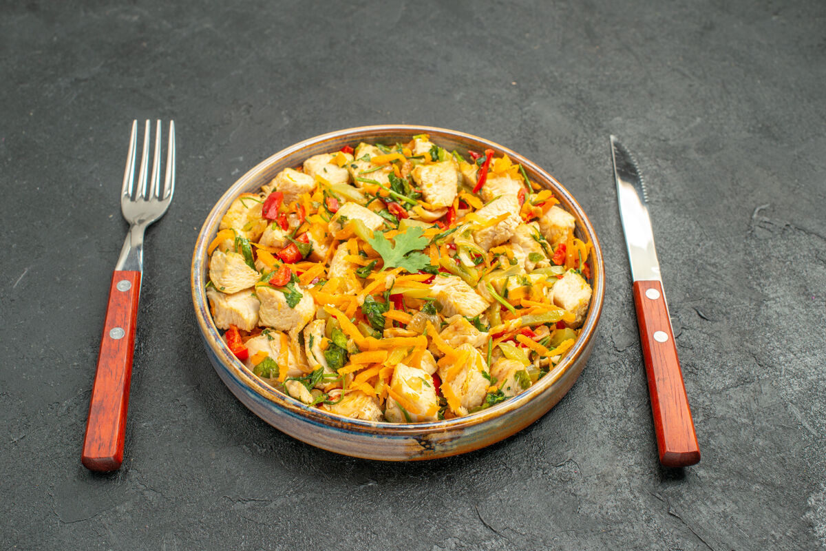 盘子前视图美味的鸡肉沙拉与切片蔬菜上黑暗的餐桌膳食饮食健康菜肴饮食切片