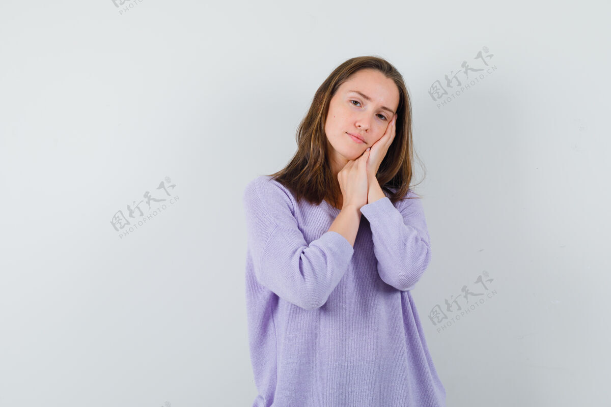 女性穿丁香衬衫的年轻女性做着枕头的姿势 看起来很累手势衬衫手