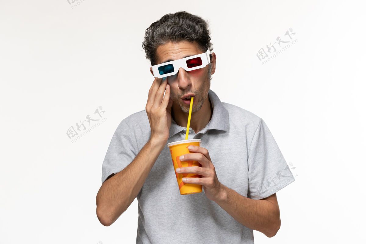 前面正面图年轻男性饮用苏打水 戴着d墨镜在浅白色表面电影苏打水手机