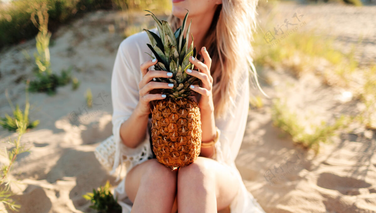 水果生活方式户外图片笑美丽的女人与多汁菠萝放松在阳光明媚的海滩时尚的夏季服装有机头发热带