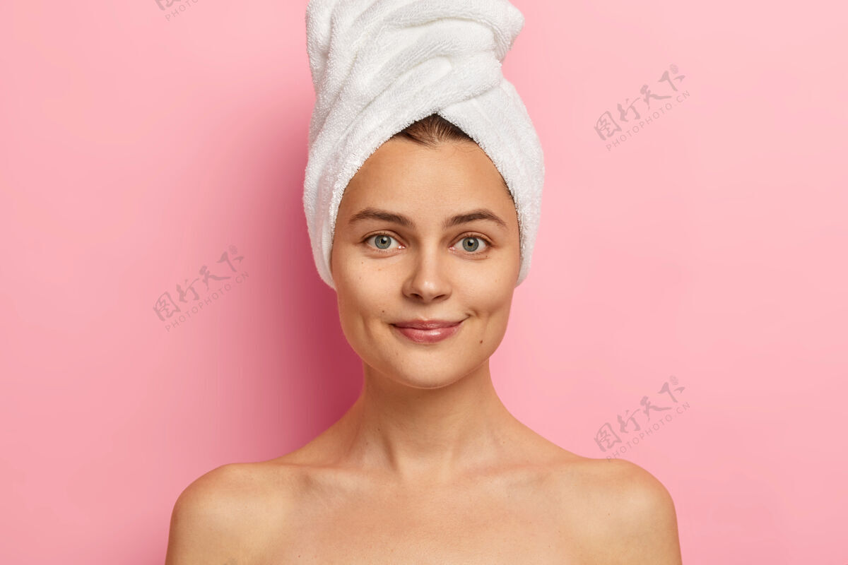 护理皮肤光滑健康的年轻女子 裸体 直视前方 蓝眼睛 头戴毛巾 在浴室洗澡身体护理模特女性