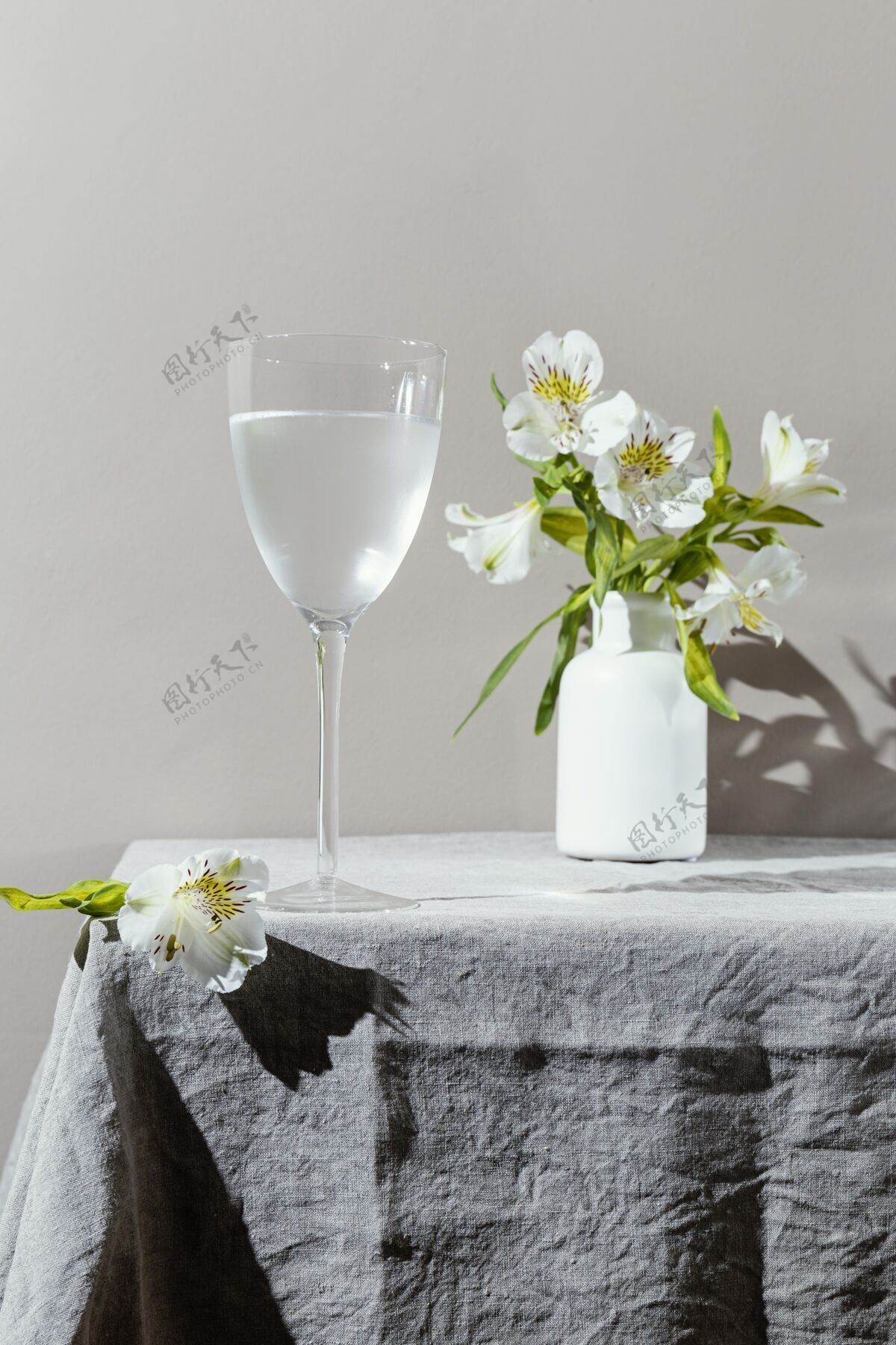 花瓶桌上有一杯水和花饮料杯子桌子