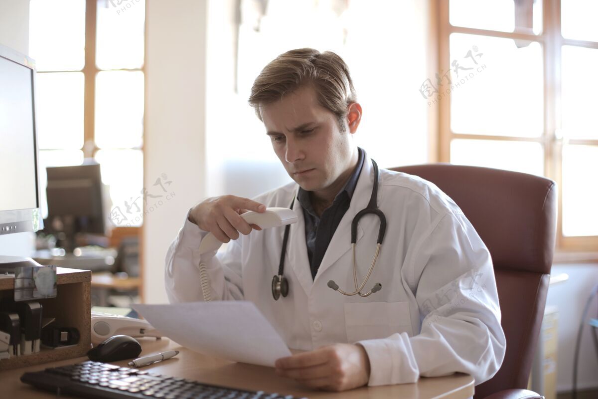 医生年轻的医生在办公室工作 背景是窗户医疗医生诊所