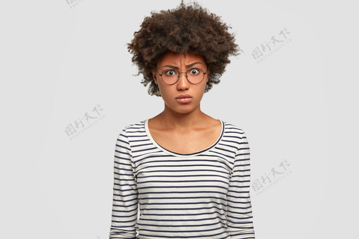 惊讶不满的非洲裔美国女性有着清爽的黑发发型照片皱眉