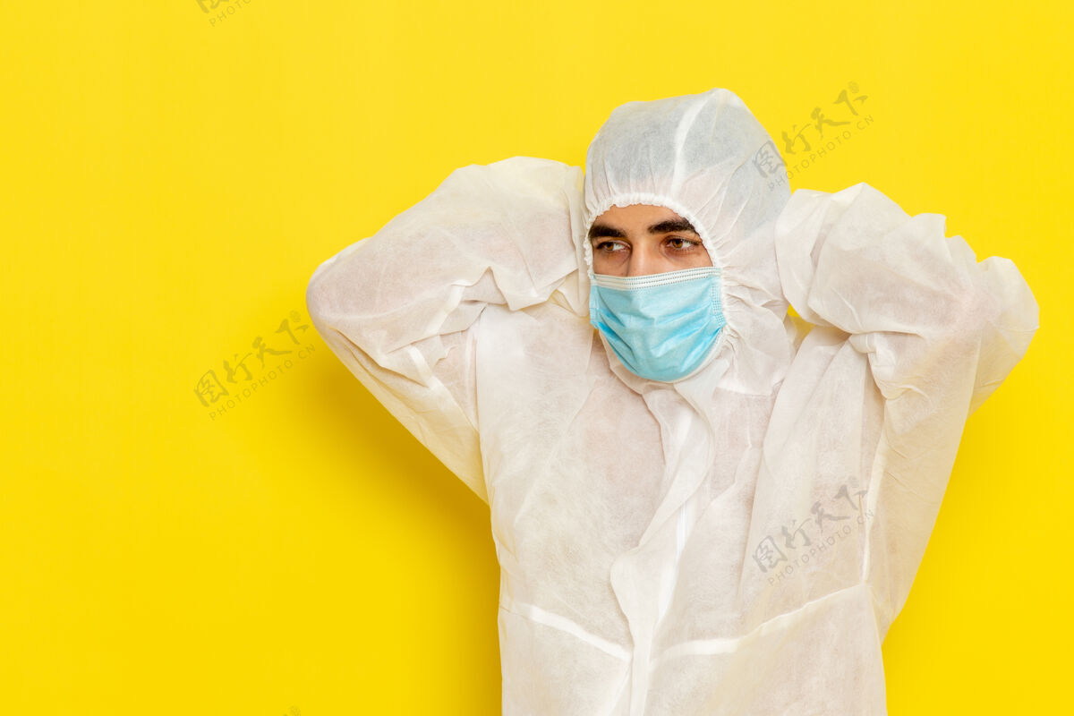 工人身穿特殊防护服 戴着浅黄色面罩的男性科学工作者的正面图科学防护危险