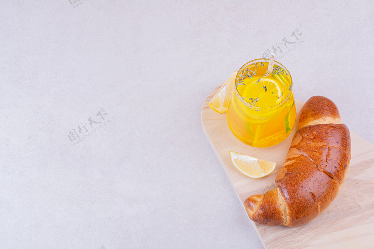 饮料一杯柠檬水加甜面包放在白盘子里零食水美味