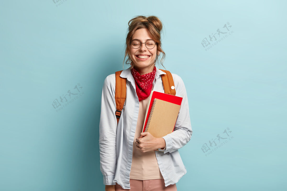 笑声高兴的少女欢笑 闭上眼睛 在课间休息时听到有趣的笑话考试高兴眼镜