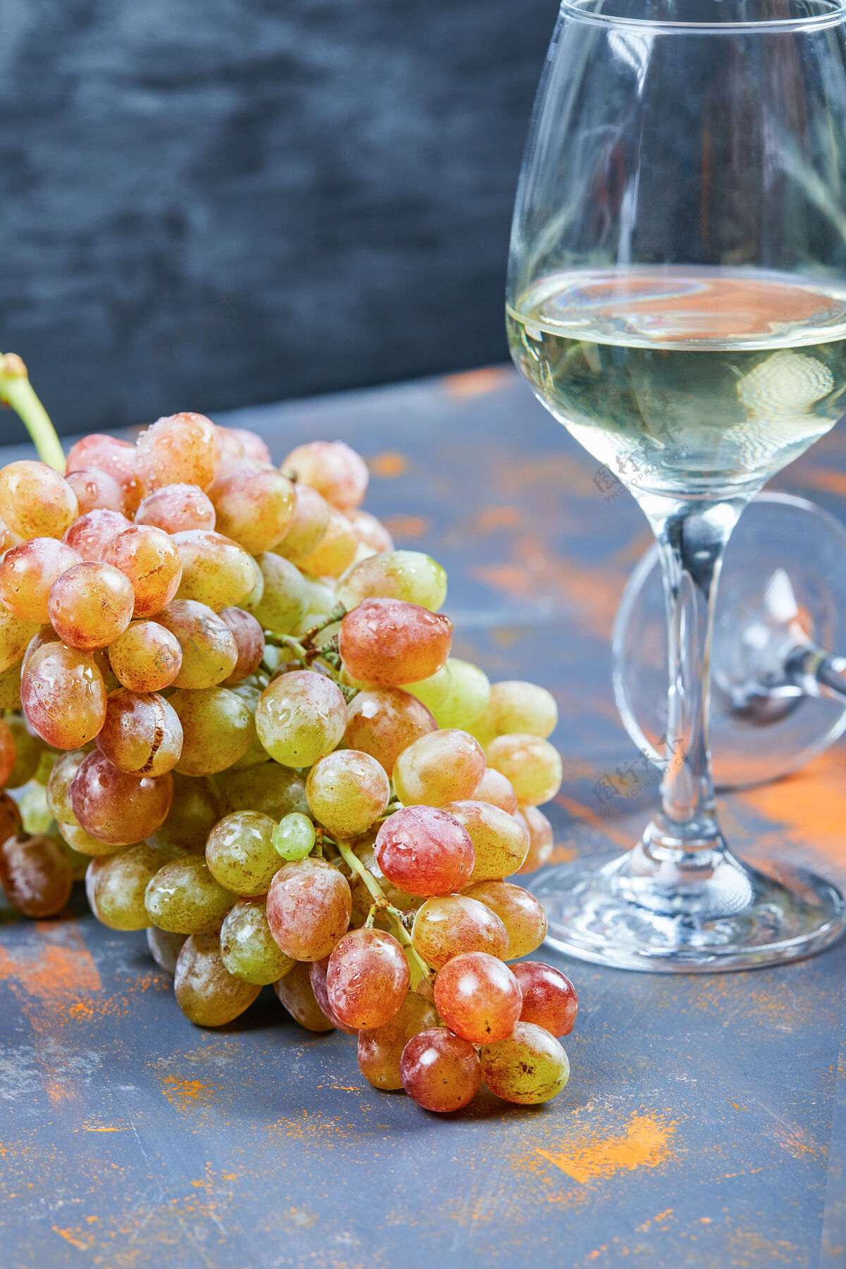 水果一束葡萄和一杯葡萄酒在蓝色的背景上高品质的照片葡萄酒餐桌酒庄